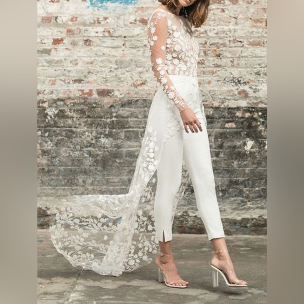 White jumpsuit with floral appliqué train